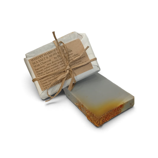 Whitby Hampers artisan soap bar with sea salt and moss, featuring a grey charcoal base and rustic paper wrapping.