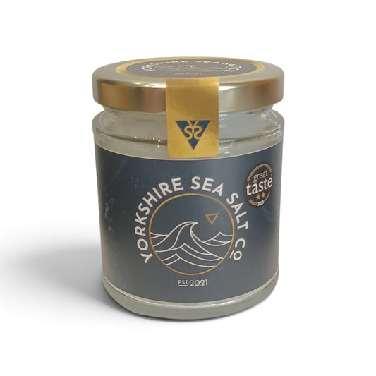 Whitby Hampers Yorkshire Sea Salt Co artisanal sea salt in a glass jar with a gold lid and navy blue label